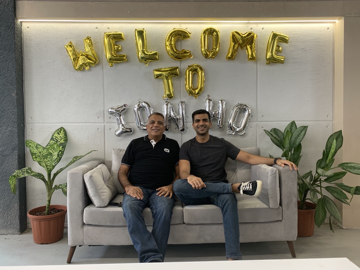 My father and me on a sofa under balloons spelling WELCOME TO IONHUB