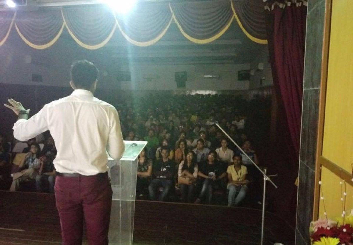 On stage with my back to the camera, in front of a full auditorium